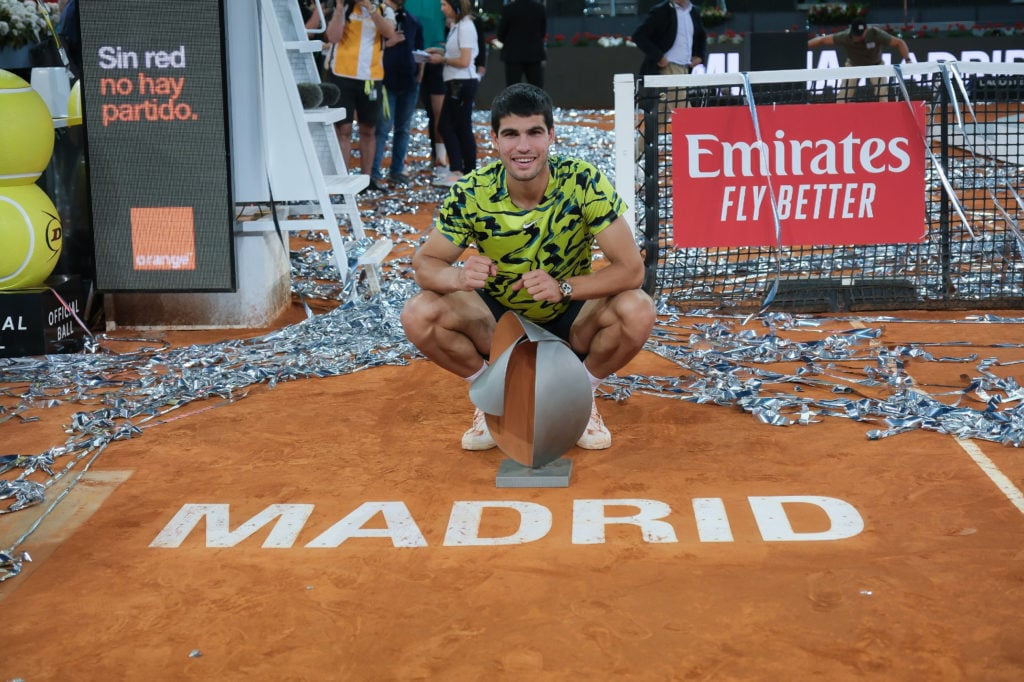 Carlos Alcaraz poses with the trophy after winning the Madrid Open in 2023.