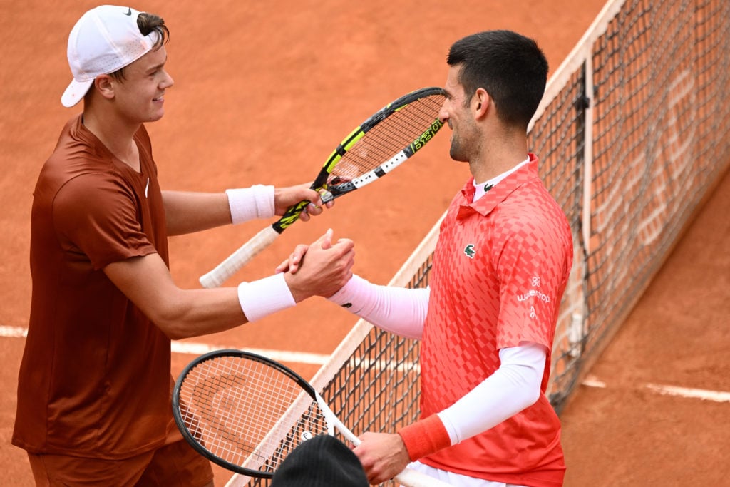 Holger Rune of Denmark greets Novak Djokovic of Serbia after