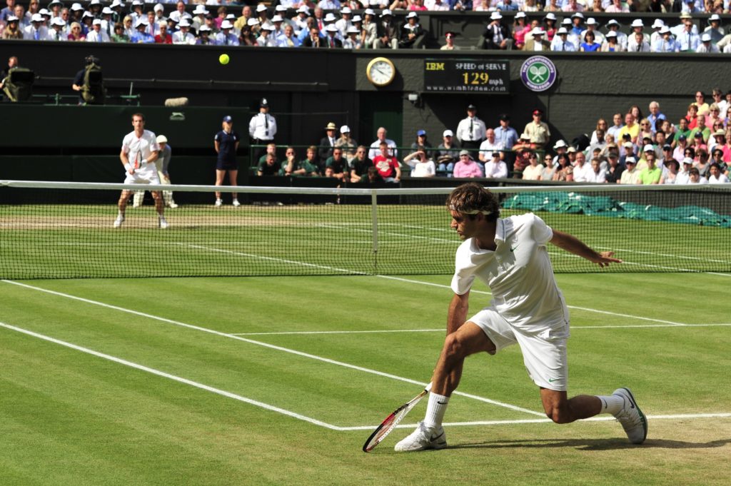 Switzerland's Roger Federer (R) plays a