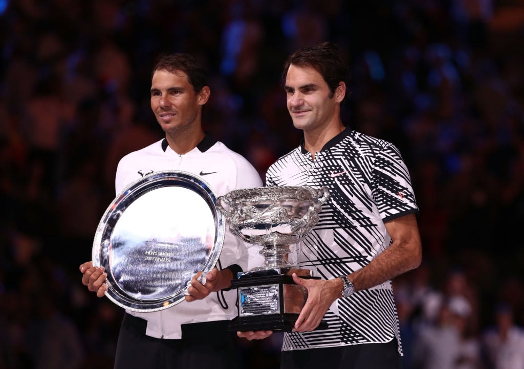 Rafael Nadal and Roger Federer holding their trophies after the 2017 Australian Open final.
