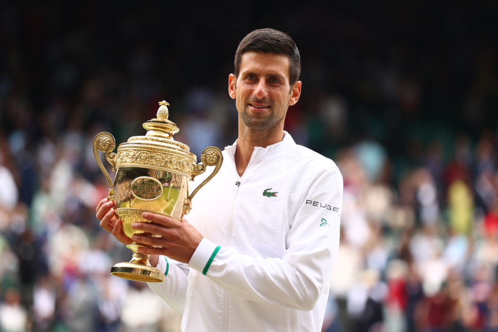 Novak Djokovic holding the Wimbledon title in 2021.
