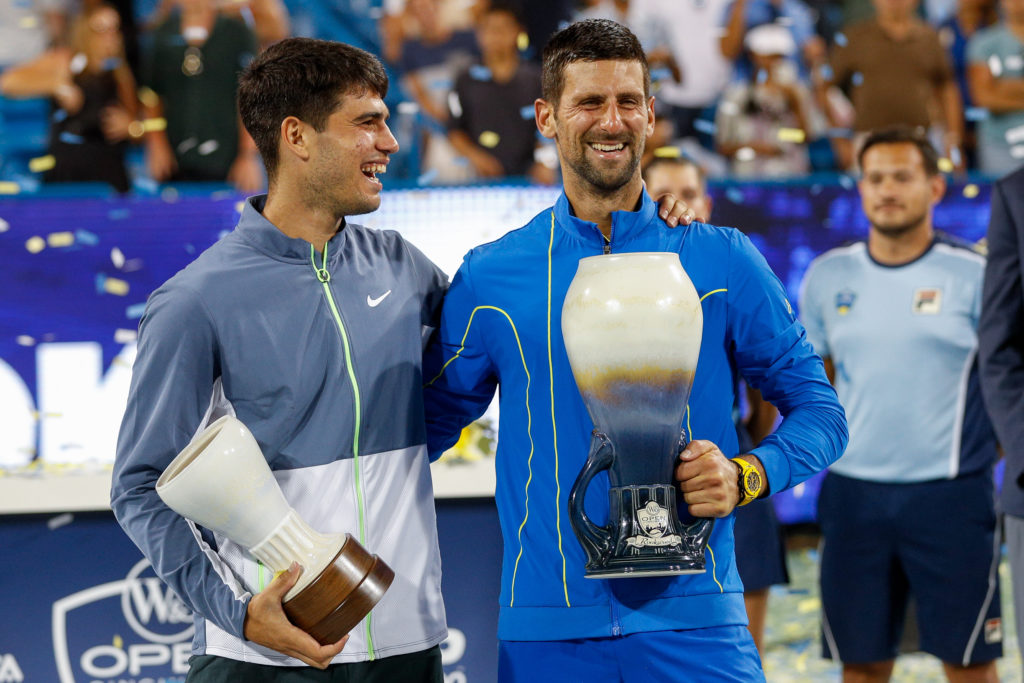 Carlos Alcaraz and Novak Djokovic holding their trophies after the 2023 Cincinnati Open final.