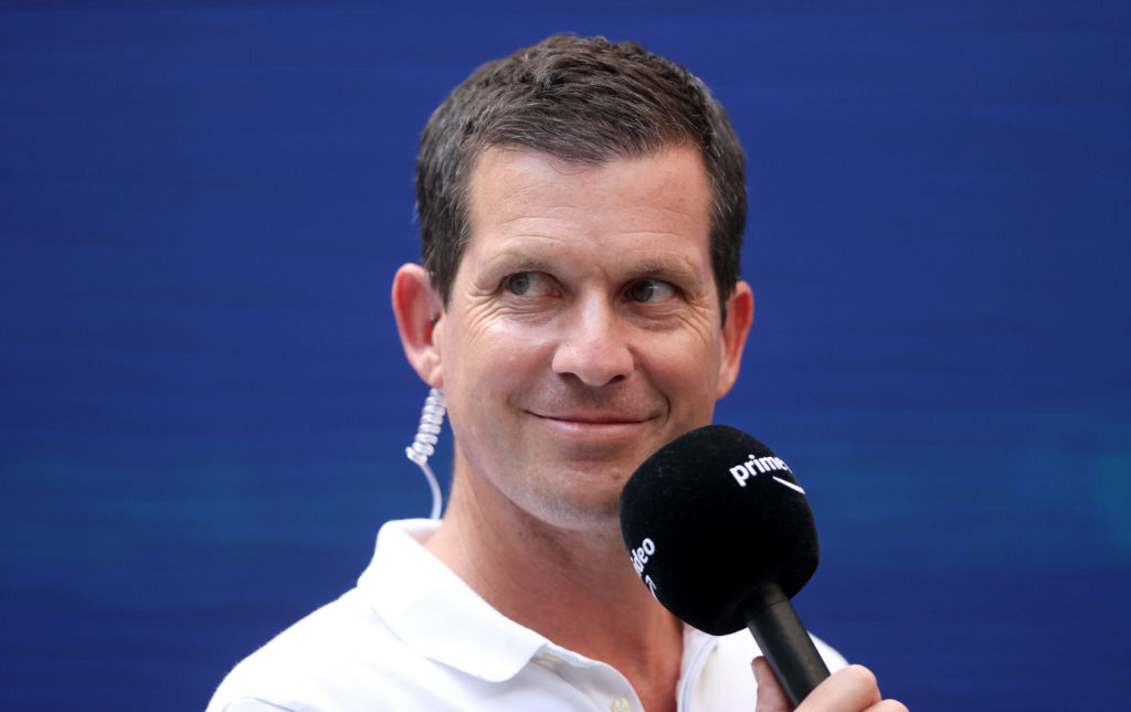 Tim Henman holding a microphone at the 2021 US Open tournament