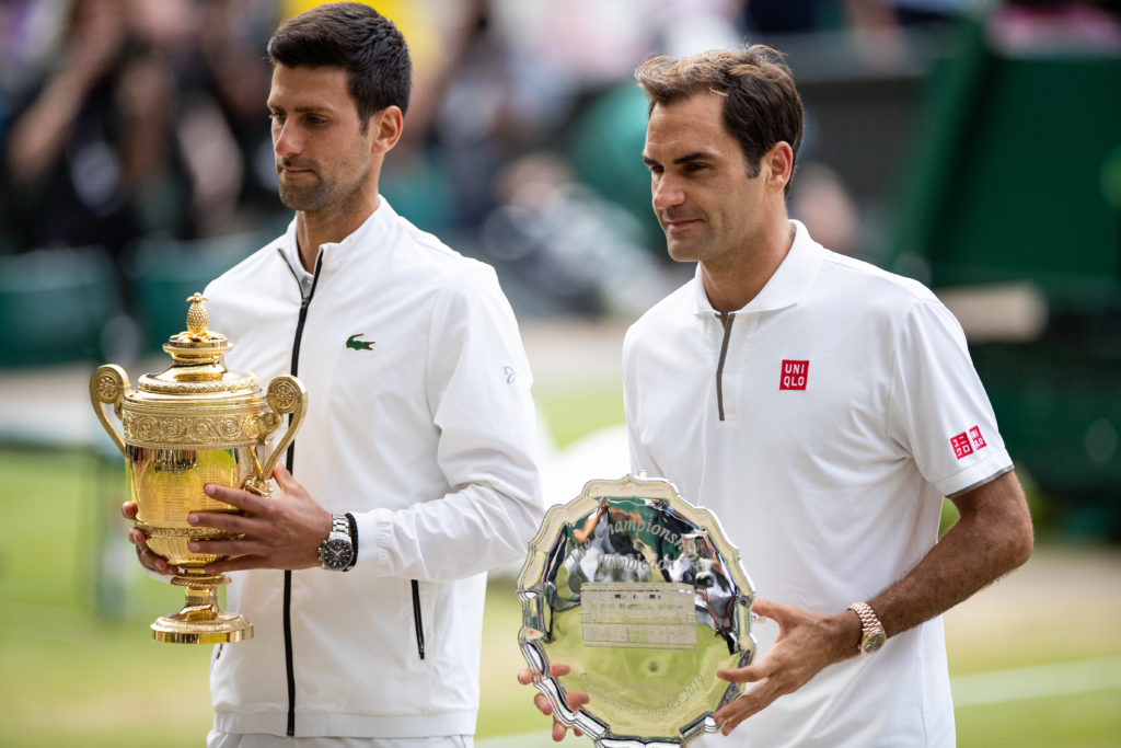 Novak Djokovic and Roger Federer celebrate with their trophies after the 2019 Wimbledon final
