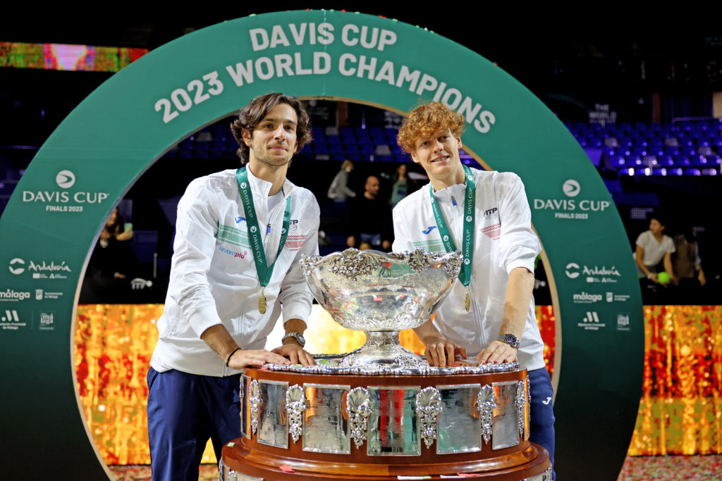 Jannik Sinner and Lorenzo Musetti pose with the Davis Cup trophy in 2023
