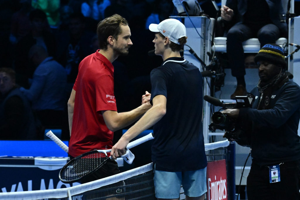 Daniil Medvedev and Jannik Sinner shake hands at the net.