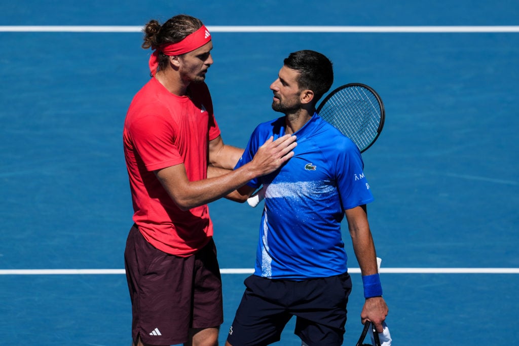 Alexander Zverev and Novak Djokovic embrace at the net after their 2025 Australian Open match
