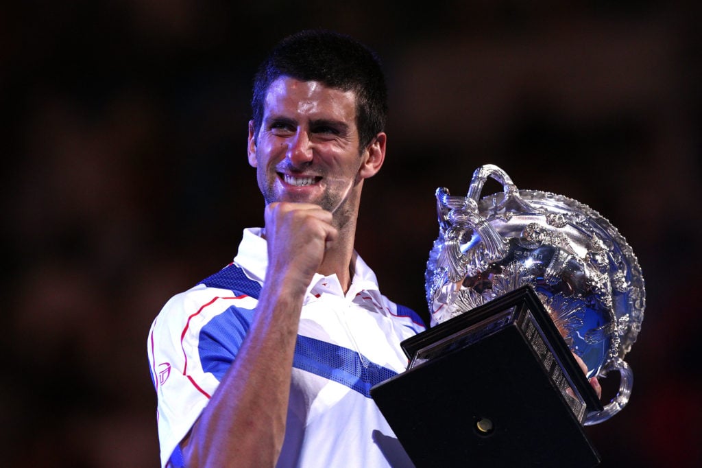 Novak Djokovic holding the 2011 Australian Open title.