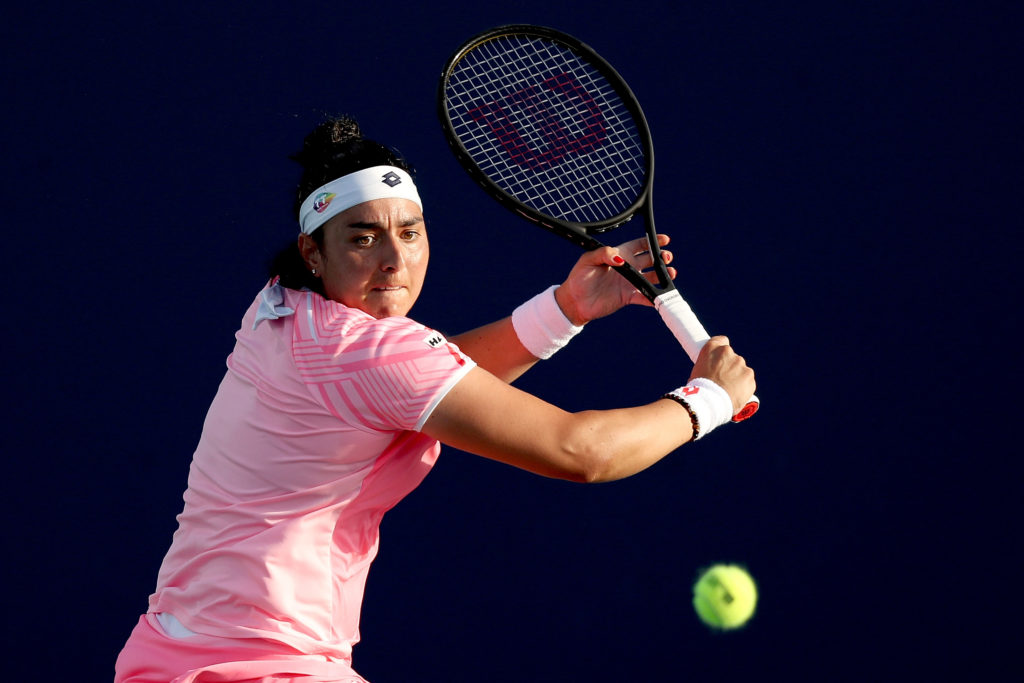 Ons Jabeur returns a shot against Sofia Kenin at the 2021 Miami Open.