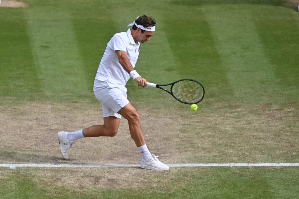 Roger Federer hits a backhand at Wimbledon