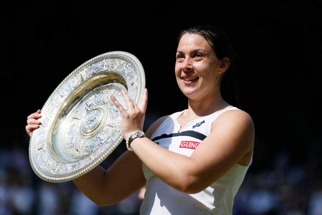 Marion Bartoli poses with the 2013 Wimbledon trophy
