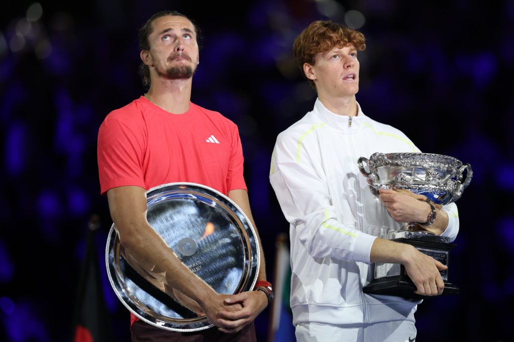 Alexander Zverev and Jannik Sinner hold their trophies after the Australian Open final in 2025.
