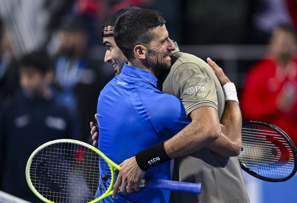 Novak Djokovic and Matteo Berrettini embrace after their match at the 2025 Qatar Open
