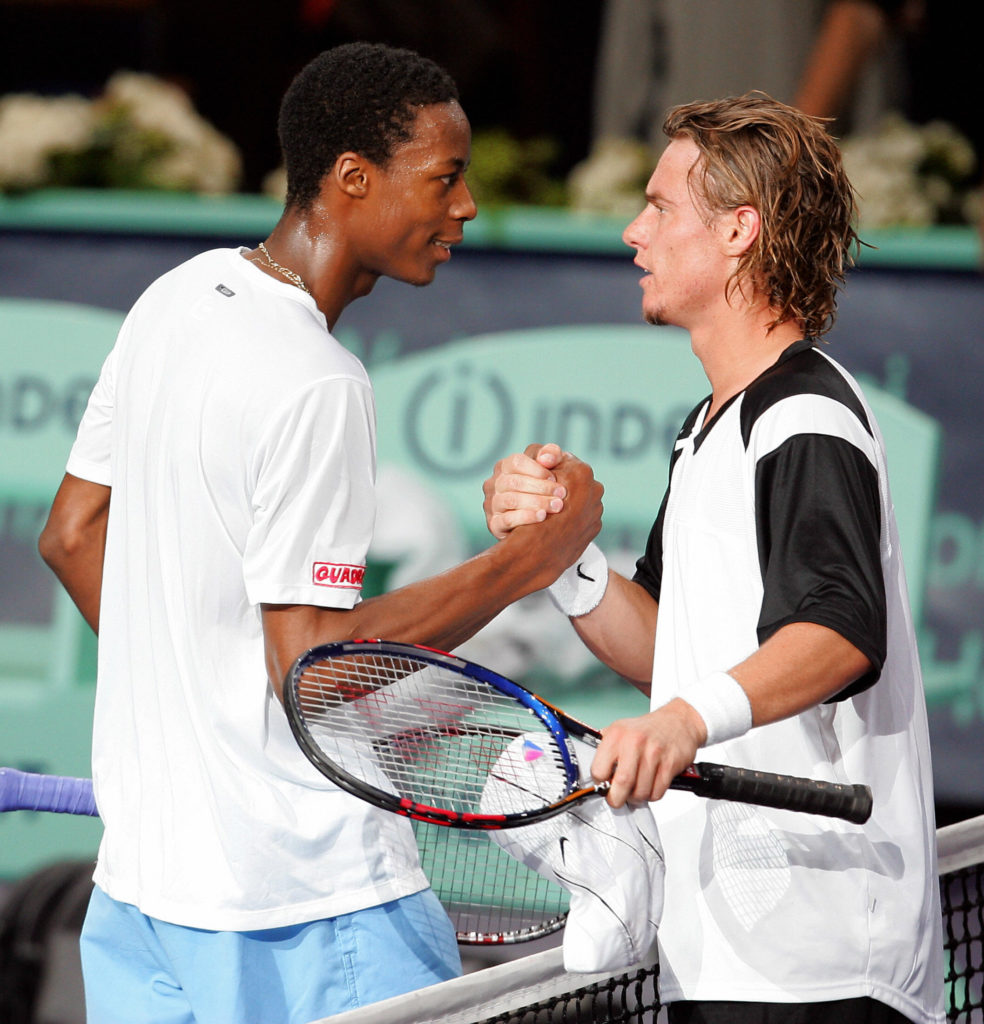 Gael Monfils of France (L) shakes hands