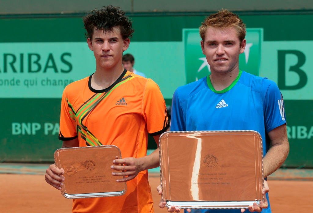 US Bjorn Fratangelo (R) holds the trophy