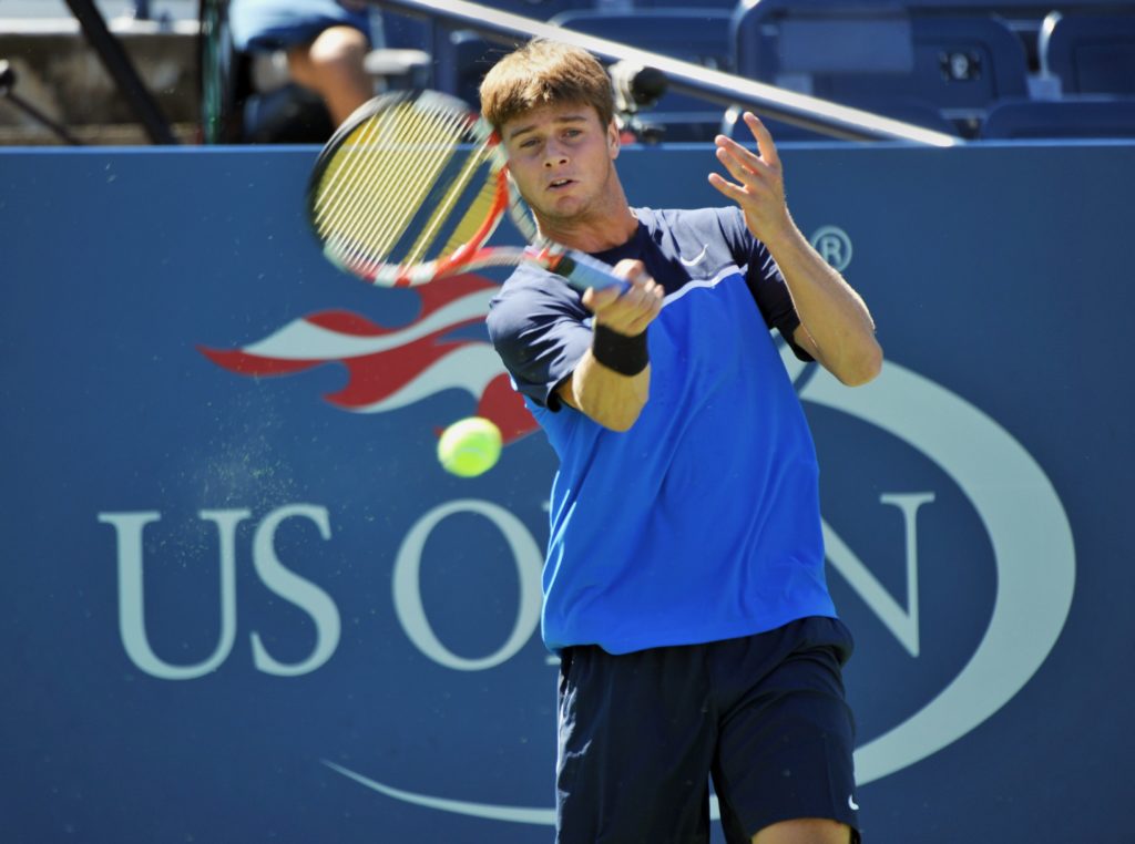 Ryan Harrison of the US returns a shot t