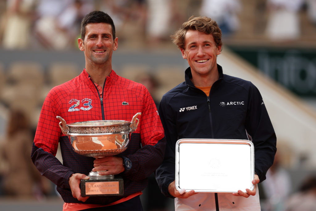 Novak Djokovic and Casper Ruud hold their trophies at the 2023 French Open.