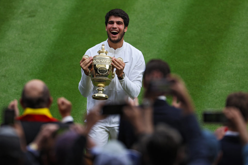 Alcaraz holding the Wimbledon 2023 title.
