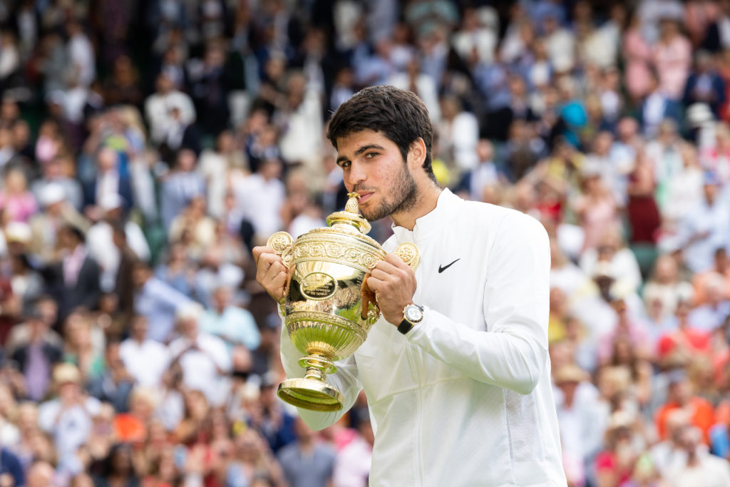 Carlos Alcaraz celebrates with the Wimbledon title after beating Novak Djokovic in the 2023 final
