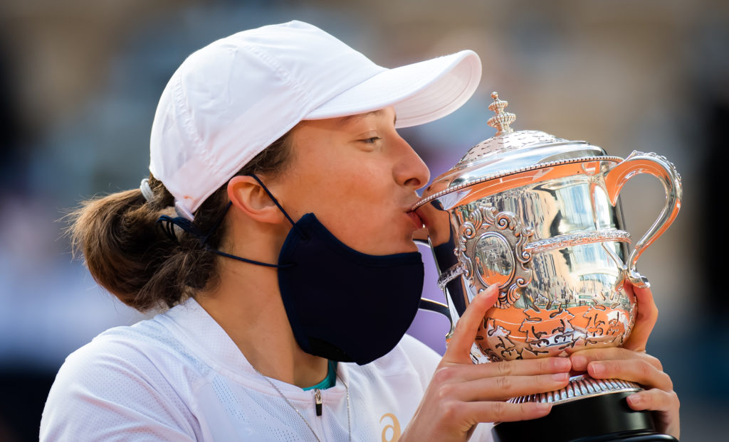 Iga Swiatek of Poland poses with the champions trophy after defeating Sofia Kenin of the United States in the singles final of Roland Garros.