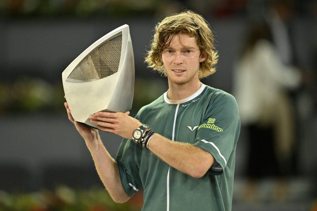 Andrey Rublev posing with the Madrid Open trophy after winning the 2024 title.