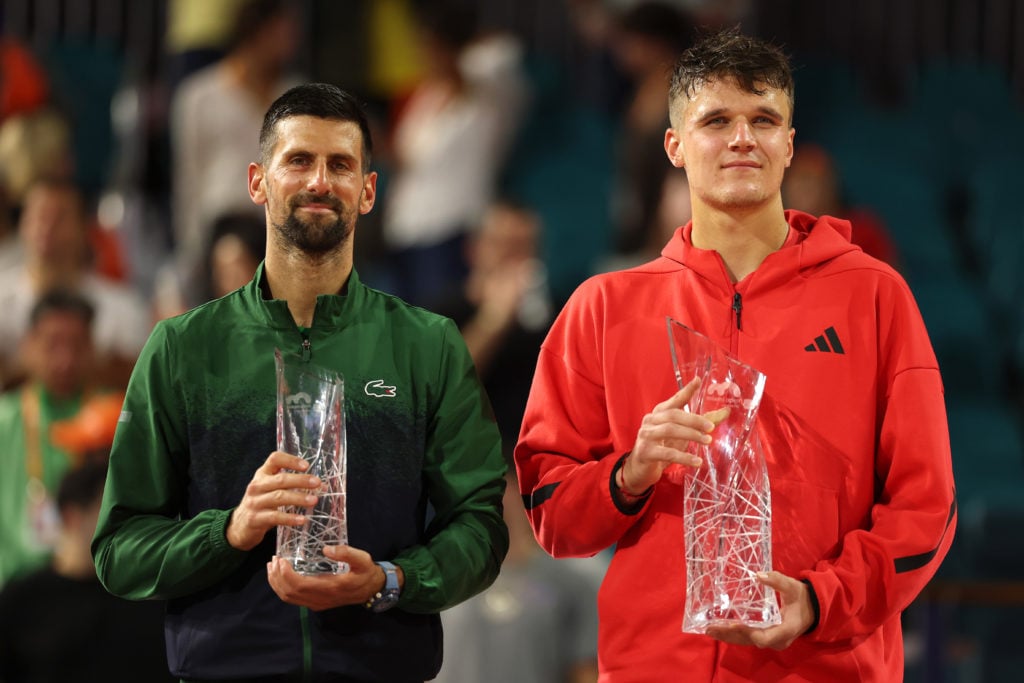 Novak Djokovic and Jakub Mensik hold their trophies at the Miami Open in 2025.
