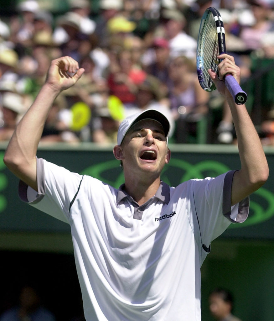 Andy Roddick of the US raises his arms after winni