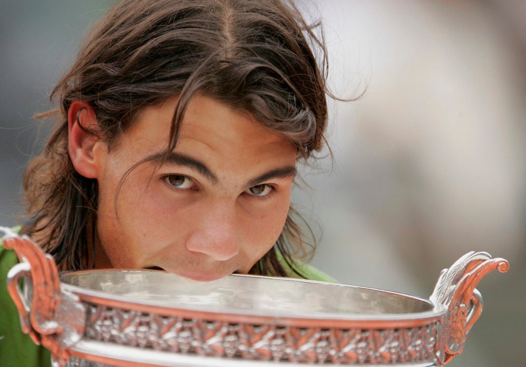 Rafael Nadal bites the Roland Garros trophy.