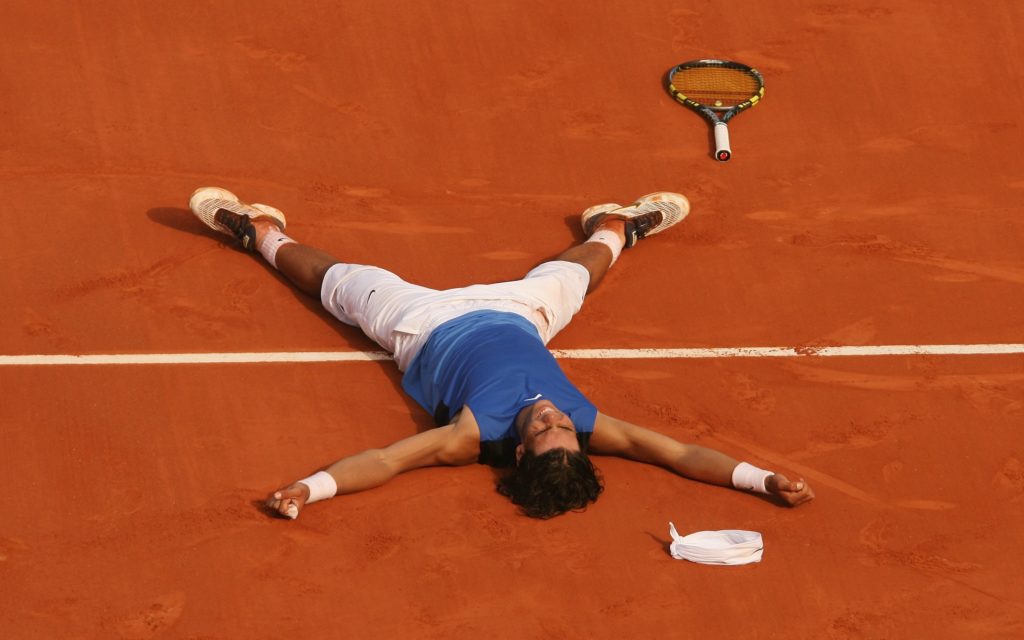 Rafael Nadal lies on the floor after winning the 2006 French Open title.
