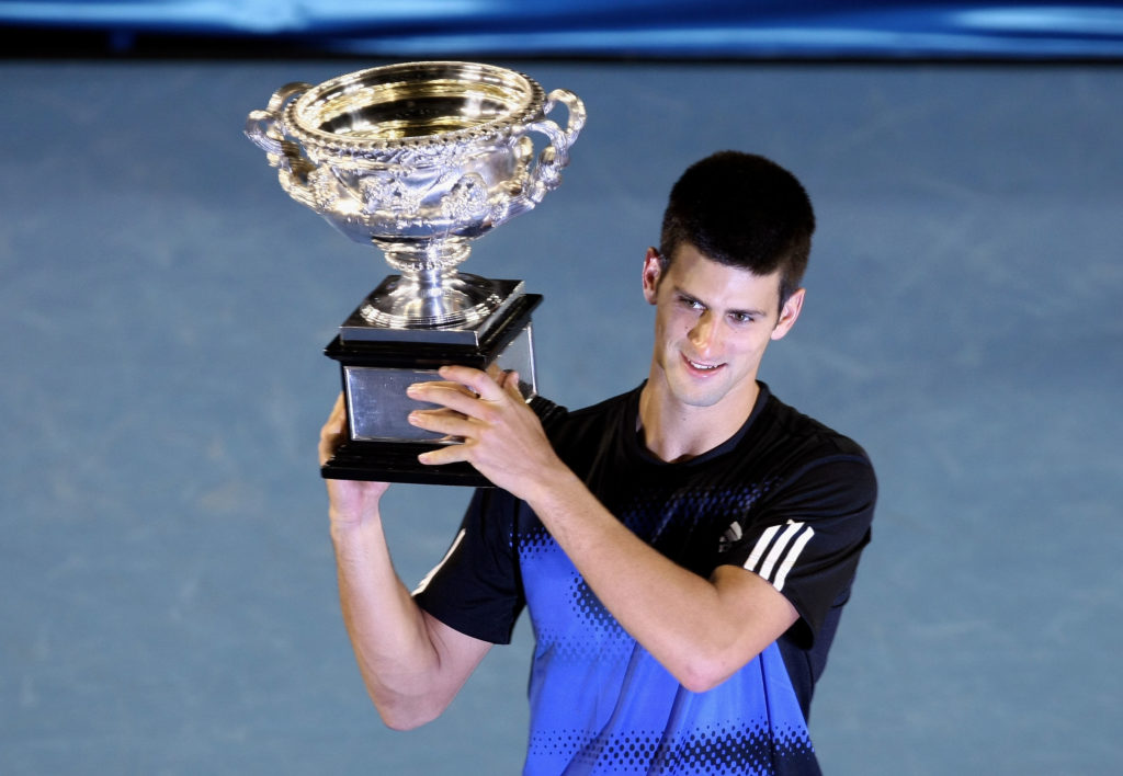 Novak Djokovic holding the 2008 Australian Open title.