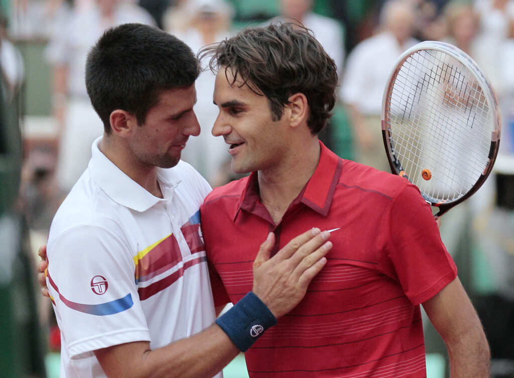 Switzerland's Roger Federer (R) reacts a