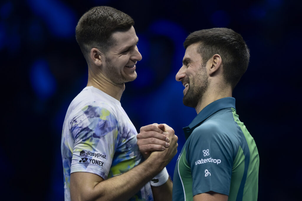 Hubert Hurkacz (L) of Poland shakes hands with Novak