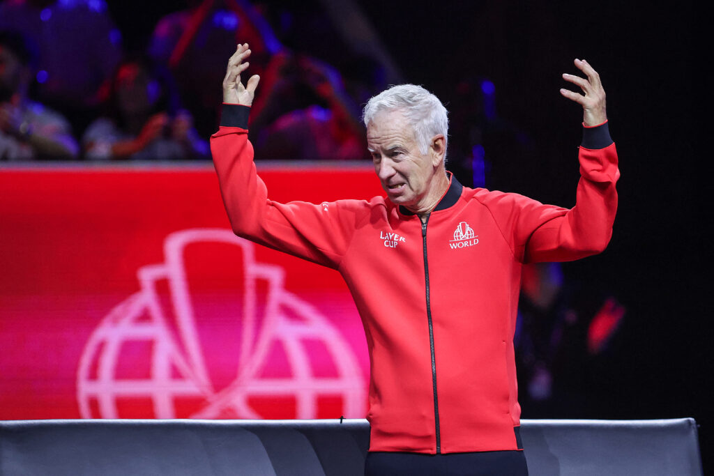 John McEnroe throws his hands in the air during the 2024 Laver Cup