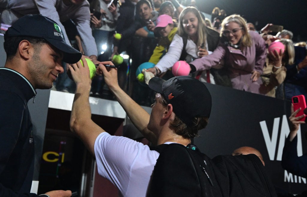 Jannik Sinner signs autographs after a training session ahead of the 2025 Italian Open