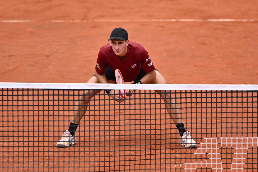 Matteo Arnaldi awaits a return during a doubles match at the 2025 Italian Open