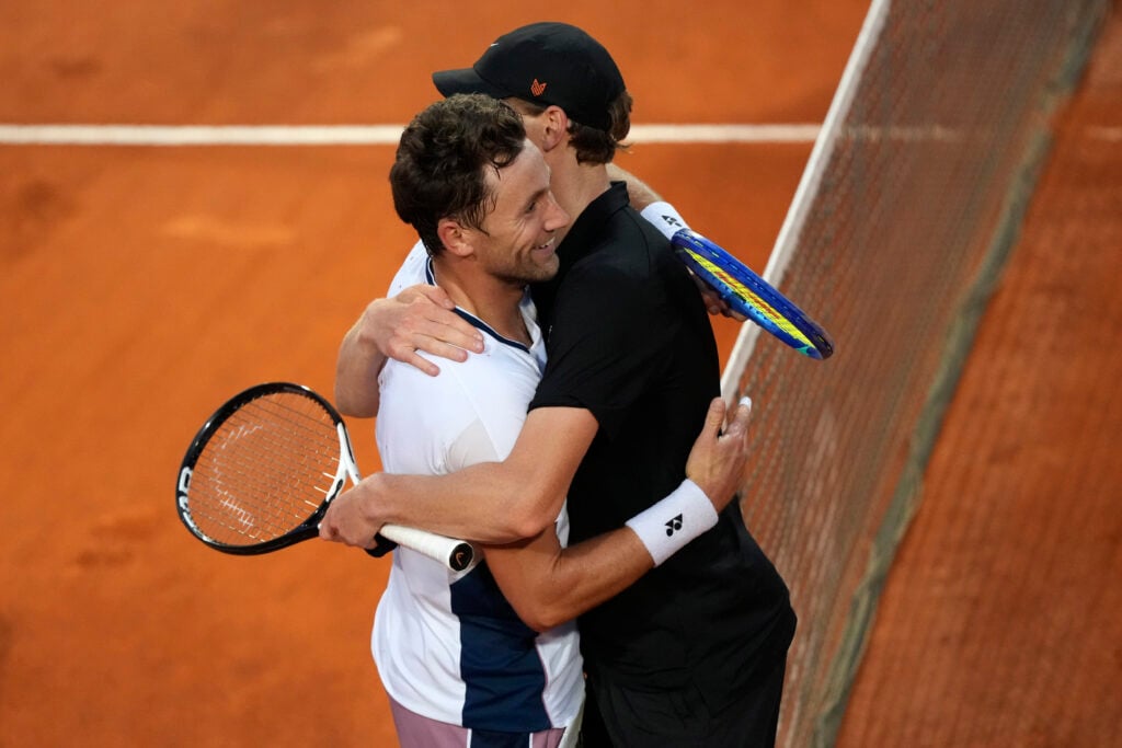 Casper Ruud of Norway and Jannik Sinner of Italy hug each other at the net after their Italian Open quarterfinal match