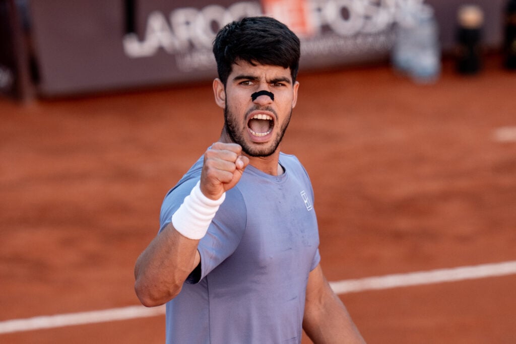 Carlos Alcaraz celebrates after beating Lorenzo Musetti at the 2025 Italian Open