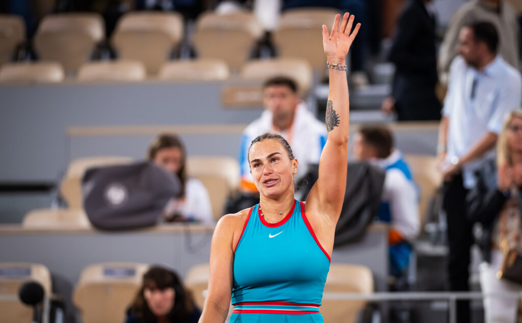 Aryna Sabalenka waves to the crowd after winning her opening match at the 2025 French Open