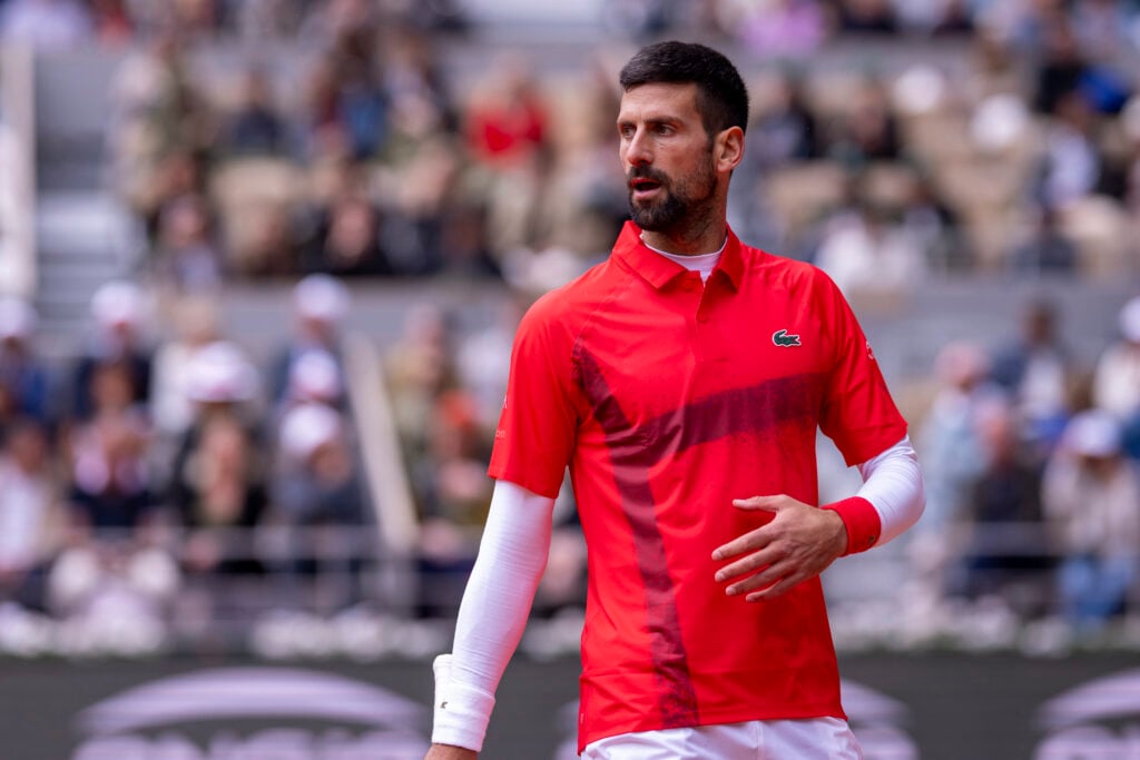 Novak Djokovic of Serbia looks on in match against Mackenzie McDonald of United States during the Men's Singles First Round match on Day Three of the 2025 French Open at Roland Garros.