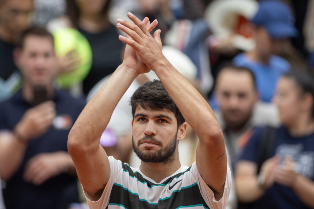 Carlos Alcaraz celebrates after winning his opening match at the 2025 French Open