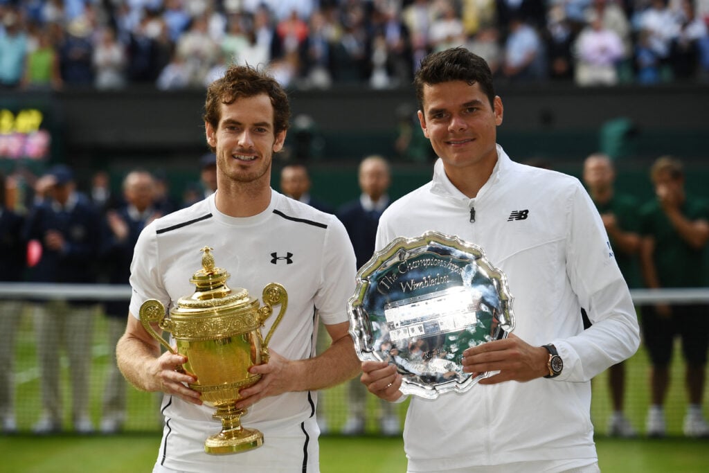 Andy Murray and Milos Raonic holding their trophies after the 2016 Wimbledon final.