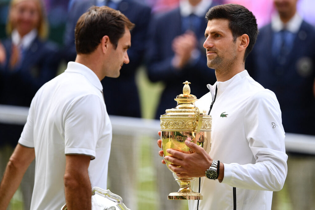 Novak Djokovic poses with the trophy after beating Roger Federer in the 2019 Wimbledon final