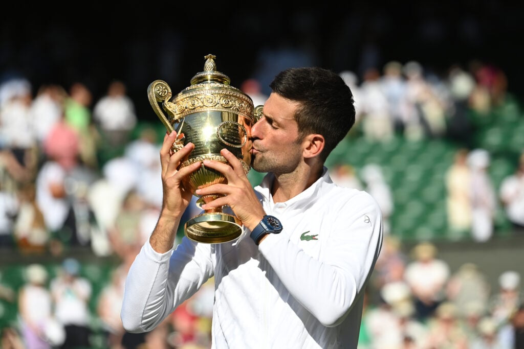 Novak Djokovic celebrates victory by holding the trophy during day fourteen of The Championships Wimbledon 2022 at All England Lawn Tennis and Croquet Club.