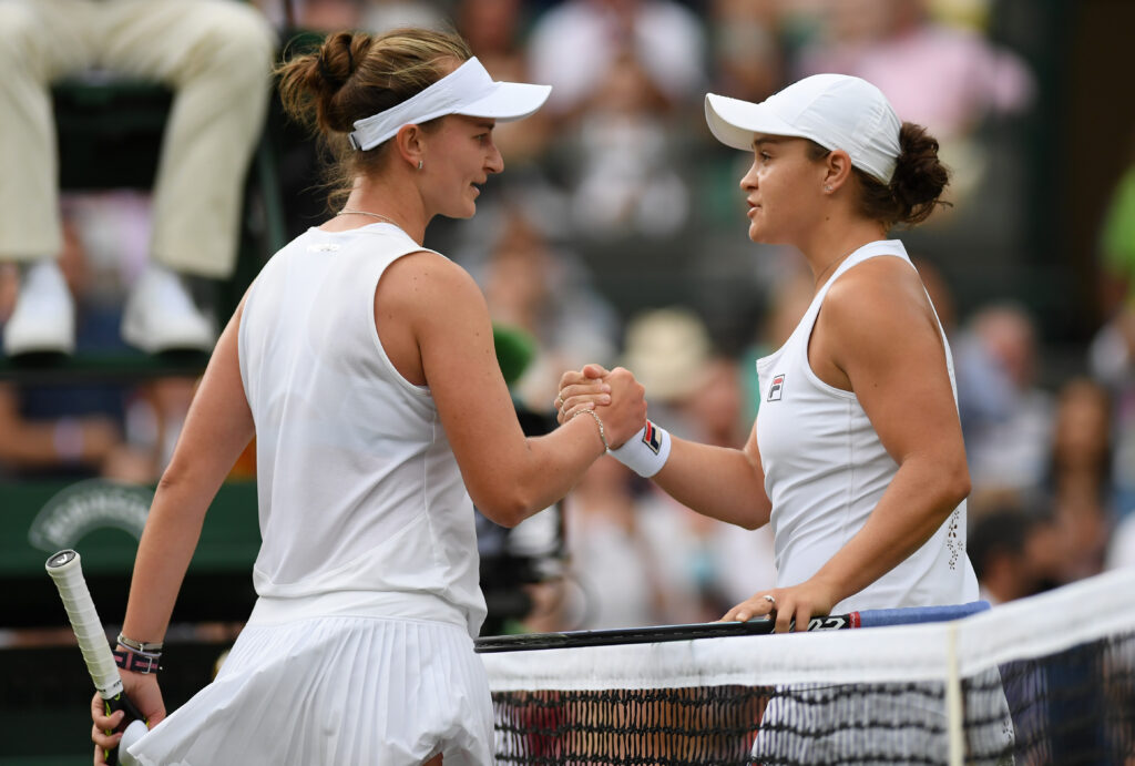 Ashleigh Barty of Australia and Barbora Krejcikova of The Czech Republic shake hands at the net after their Ladies' Singles Fourth Round match during Day Seven of The Championships - Wimbledon 2021 at All England Lawn Tennis and Croquet Club.
