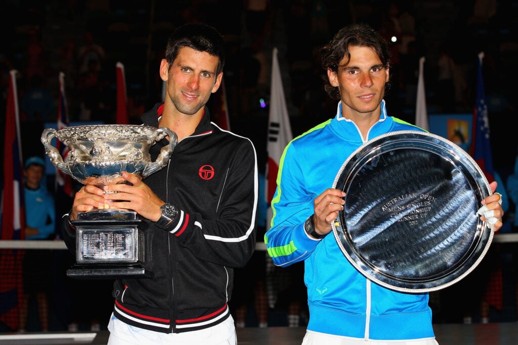Novak Djokovic and Rafael Nadal pose with their trophies after the 2012 Australian Open final