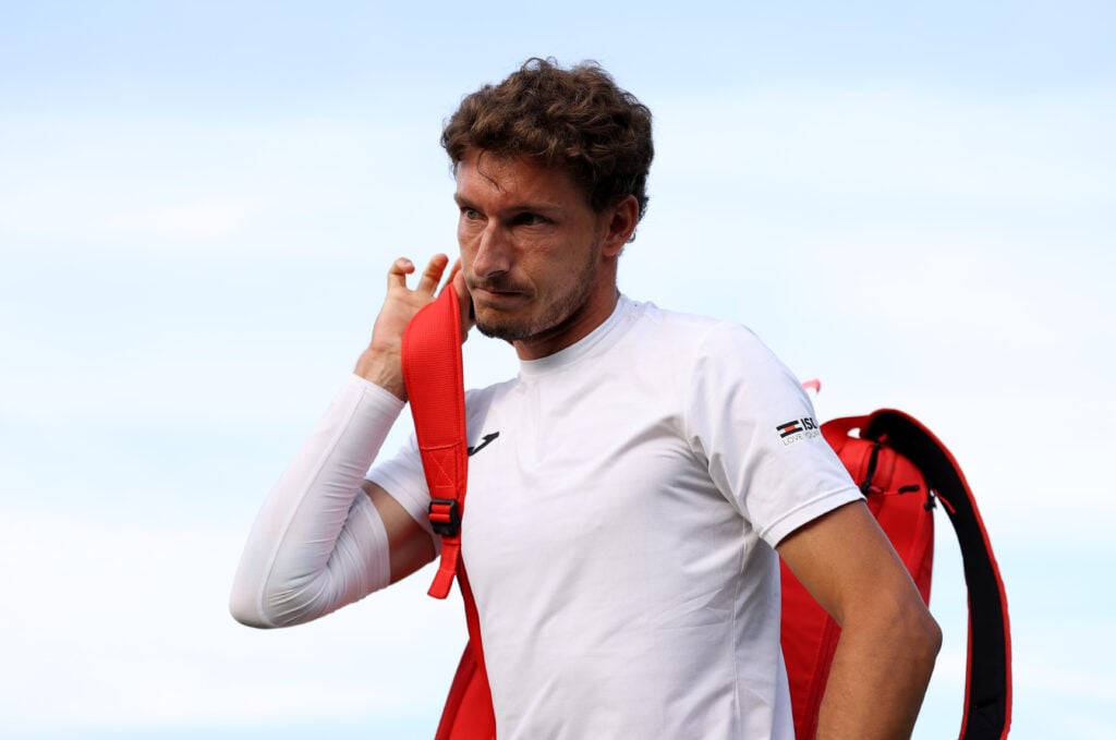 ablo Carreno Busta of Spain retires with an injury against Dusan Lajovic of Serbia during the Men's Singles First Round match during Day One of The Championships Wimbledon 2022 at All England Lawn Tennis and Croquet Club.