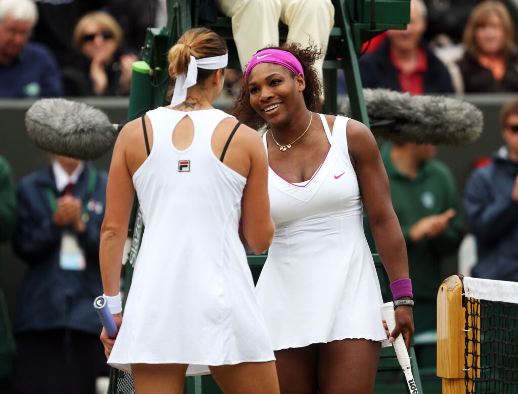 Serena Williams and Yaroslava Shvedova embrace at the net after their match at Wimbledon in 2012