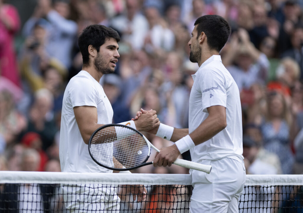 Novak Djokovic and Carlos Alcaraz embrace at the net after the 2023 Wimbledon final
