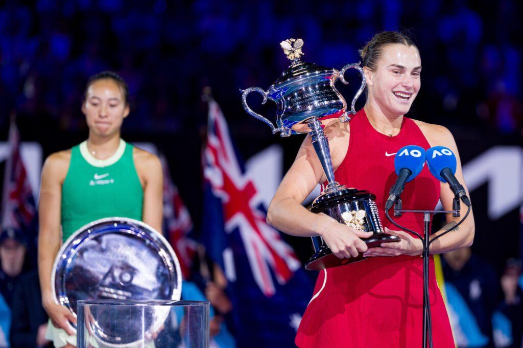 Aryna Sabalenka and Qinwen Zheng hold their trophies after the 2024 Australian Open final