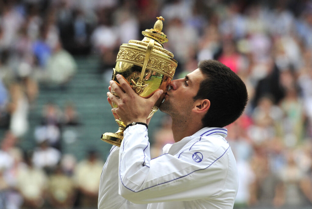 Novak Djokovic kissing the Wimbledon trophy in 2011.